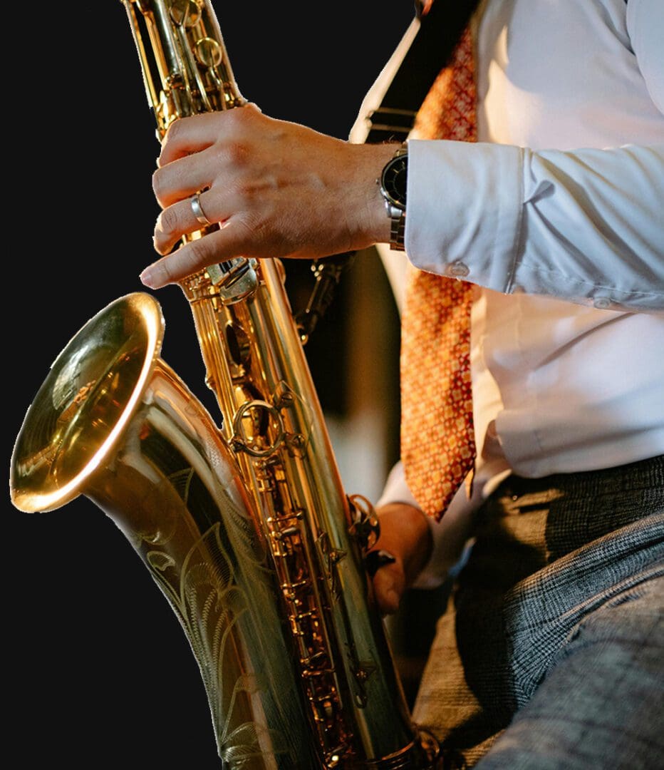 A man playing the saxophone in front of other people.